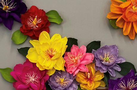 colorful crepe paper flowers on a gray background