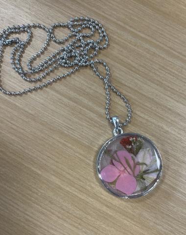 romantic pendant with delicate flowers in an epoxy resin